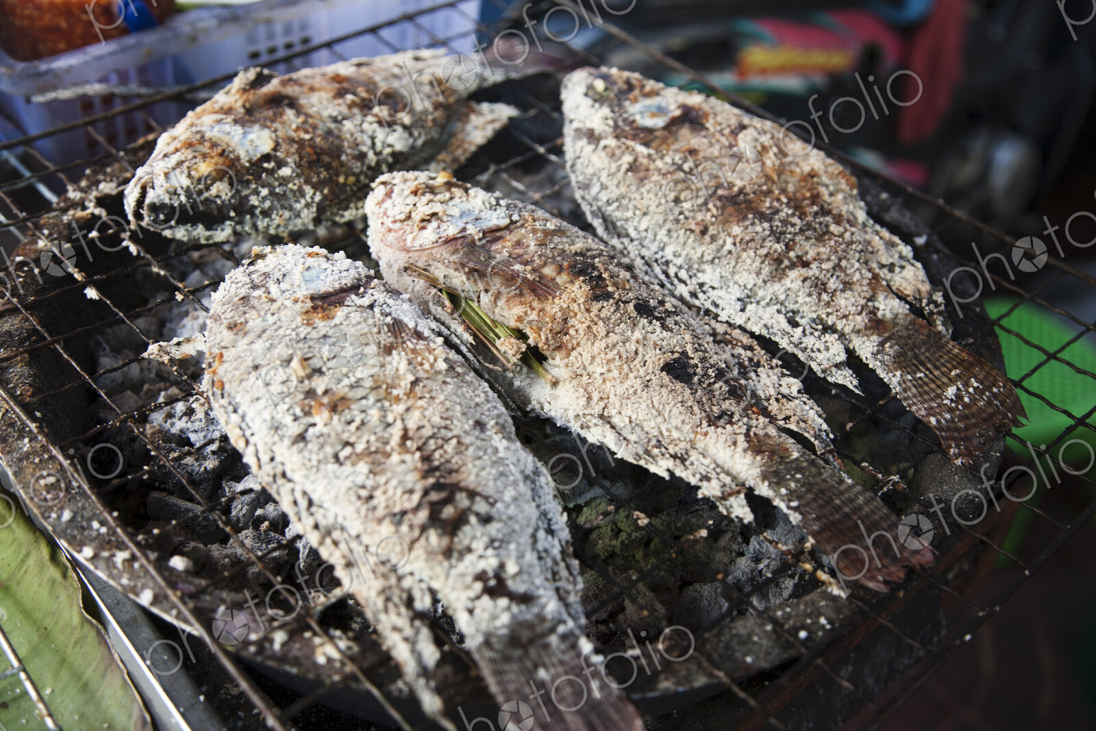 Street food in China town, a small stall with cooked fish in Bangkok, Thailand.