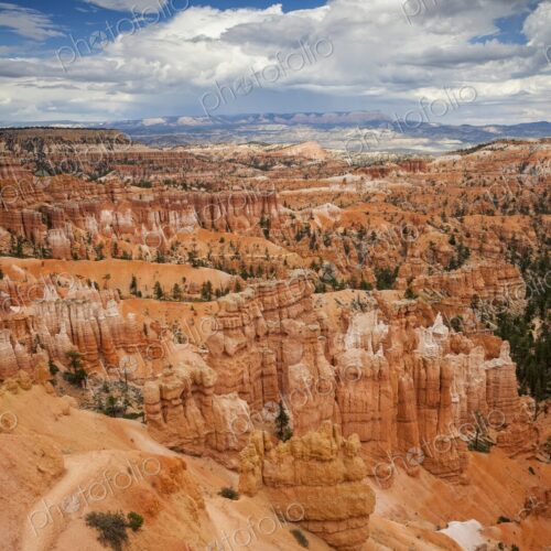 Striking view of Bryce Canyon's hoodoo formations and orange cliffs under a dramatic… Striking view of Bryce Canyon's hoodoo formations and orange cliffs under a dramatic…