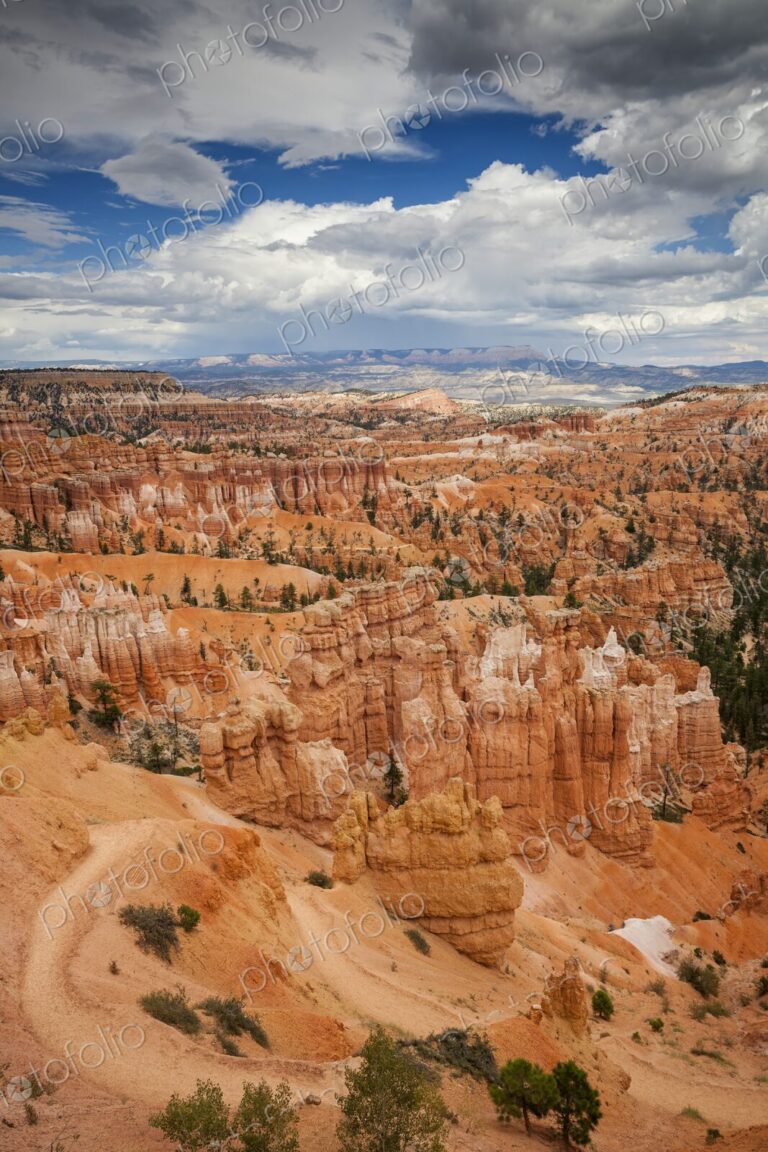 Striking view of Bryce Canyon's hoodoo formations and orange cliffs under a dramatic…