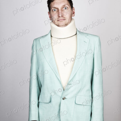 Studio portrait of a Caucasian man actor wearing neck brace.