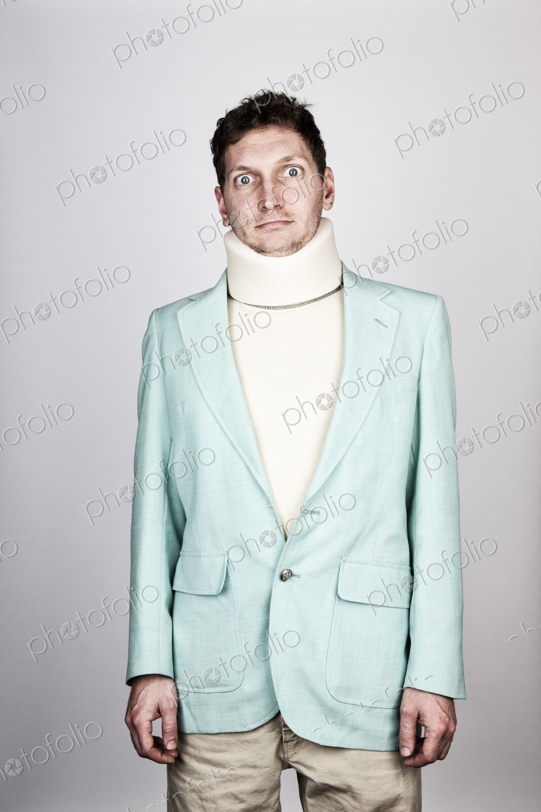Studio portrait of a Caucasian man actor wearing neck brace.