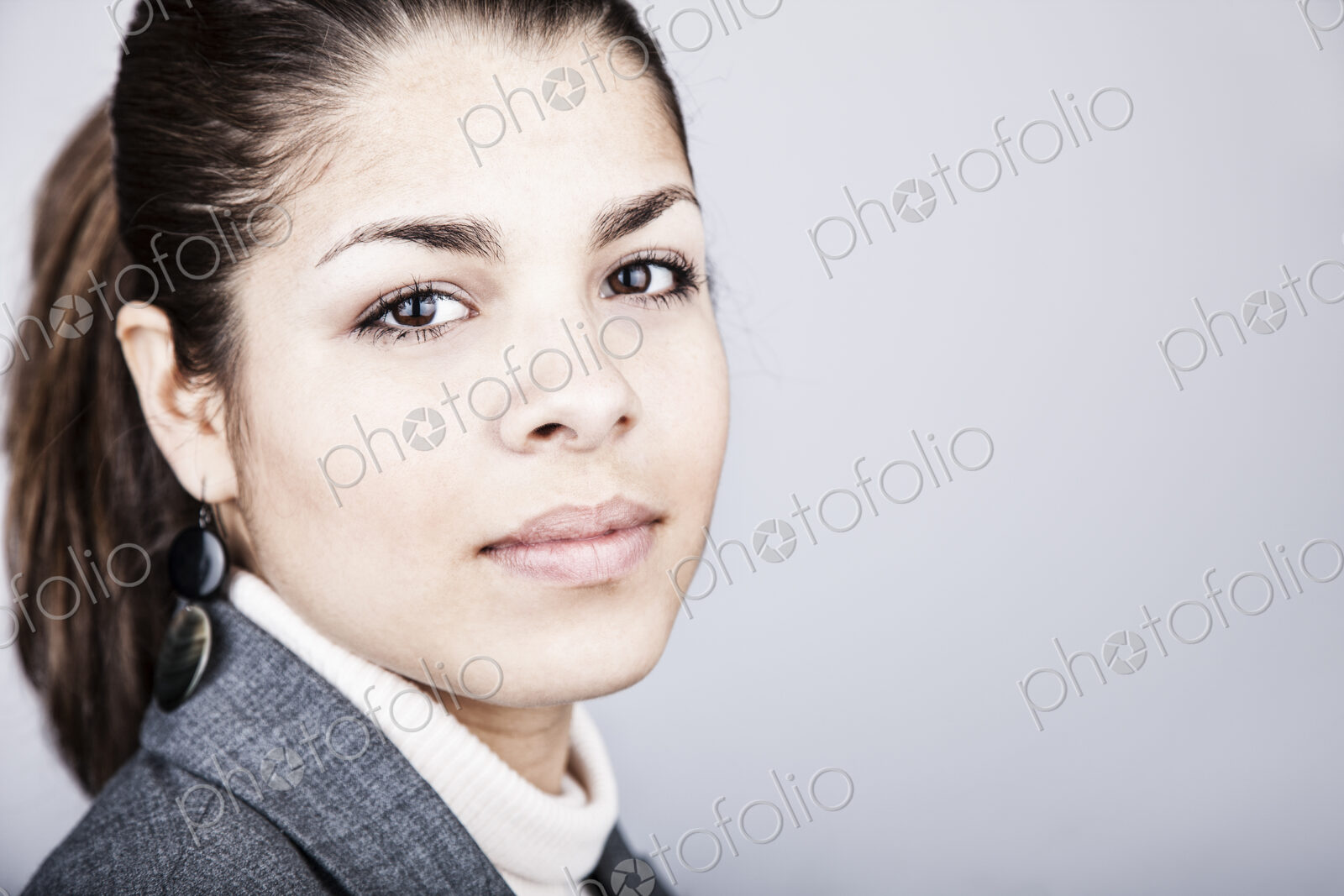 Studio portrait of a young Hispanic woman