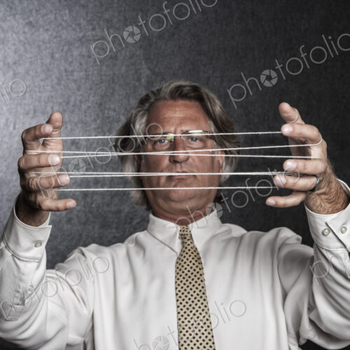 Studio portrait of caucasian man actor holding up his hands and looking at a cat's… Studio portrait of caucasian man actor holding up his hands and looking at a cat's…