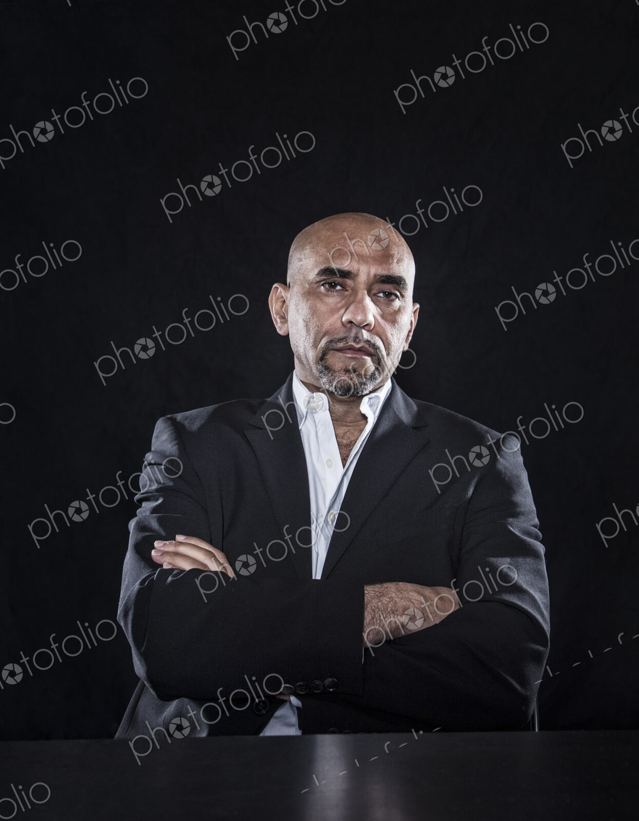 Studio portraits of hispanic man holding props.