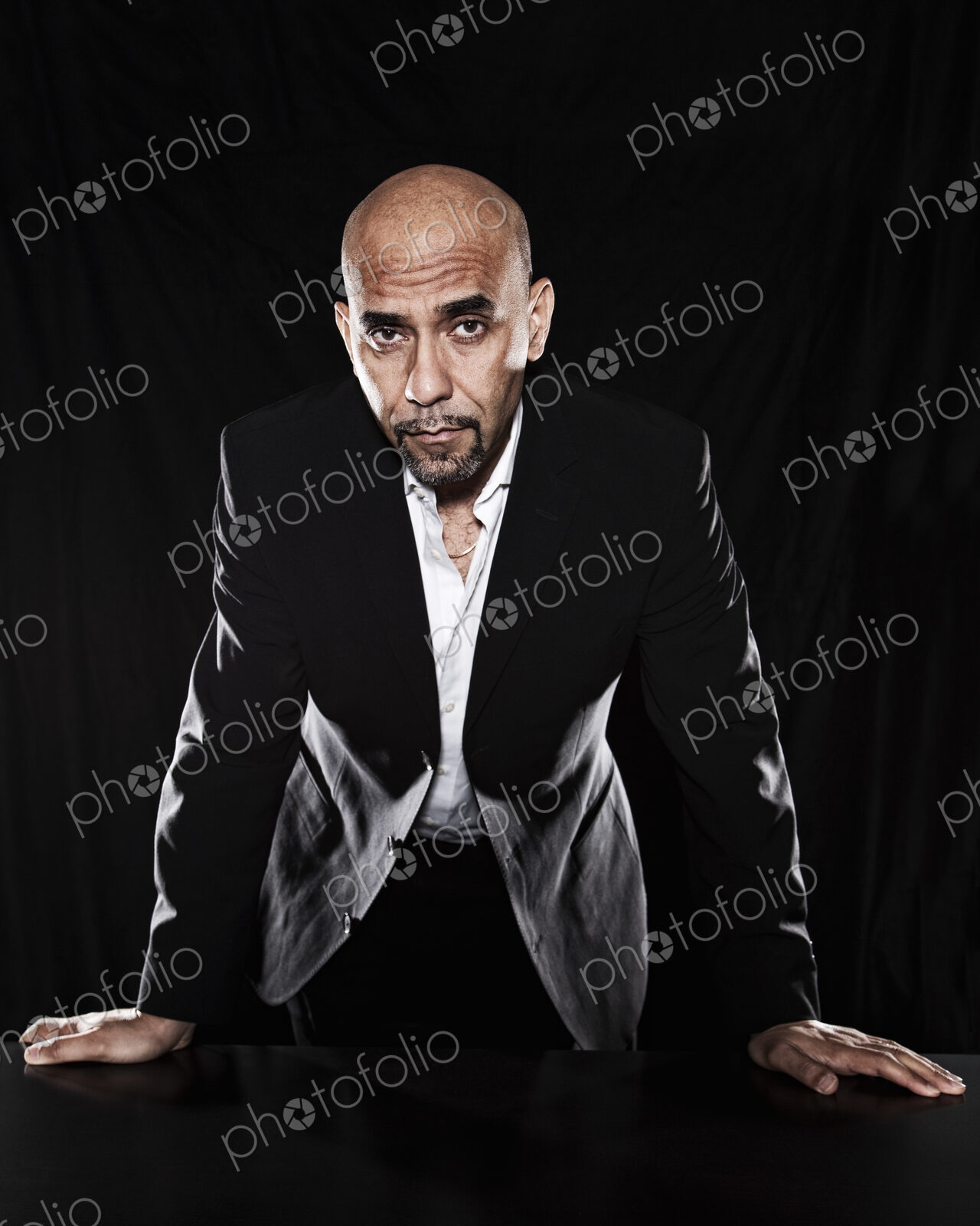 Studio portraits of hispanic man holding props.