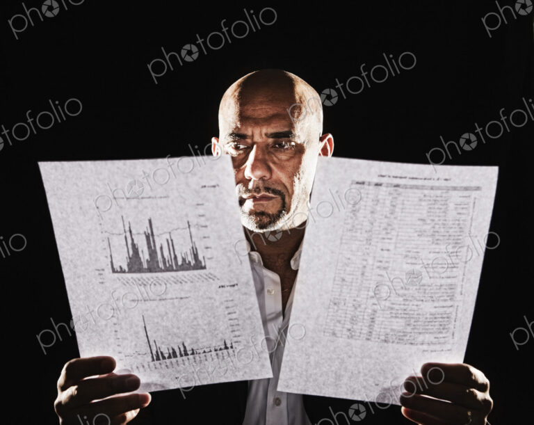 Studio portraits of hispanic man holding props.