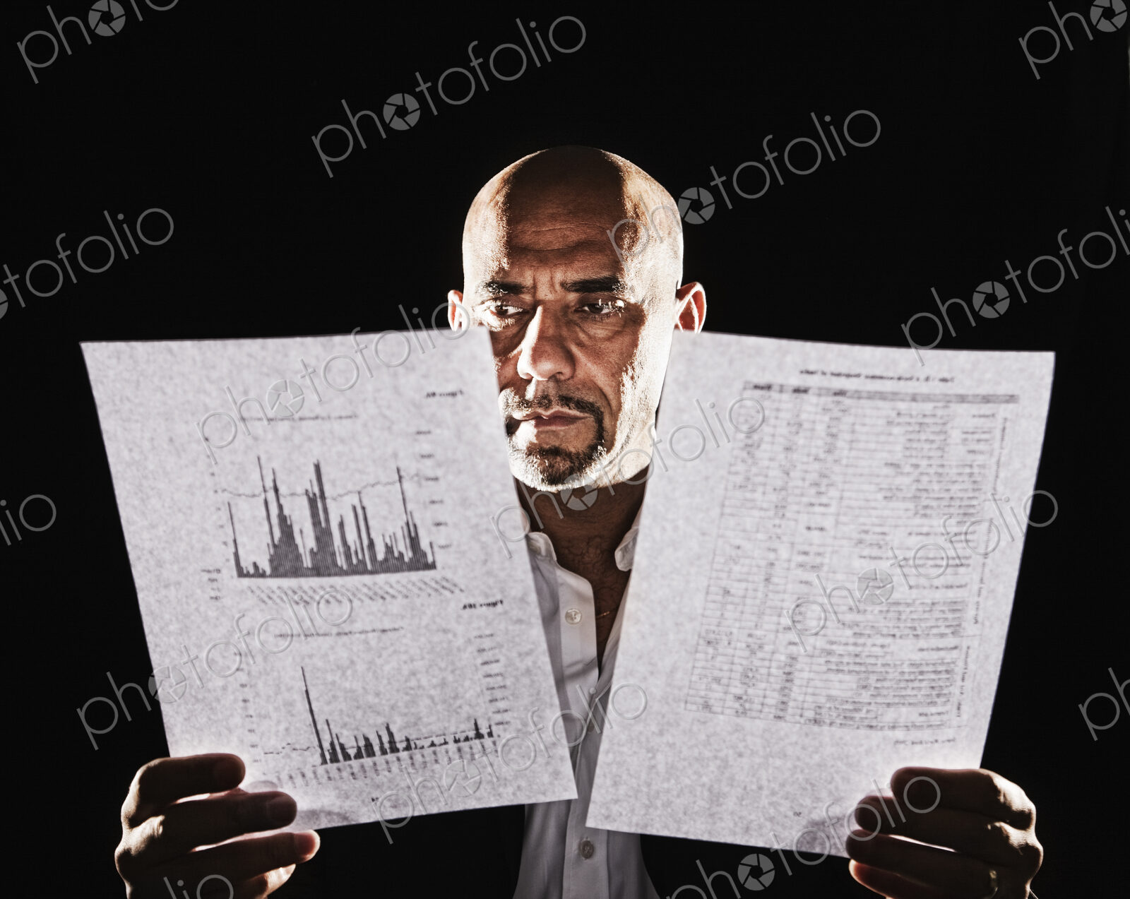 Studio portraits of hispanic man holding props.