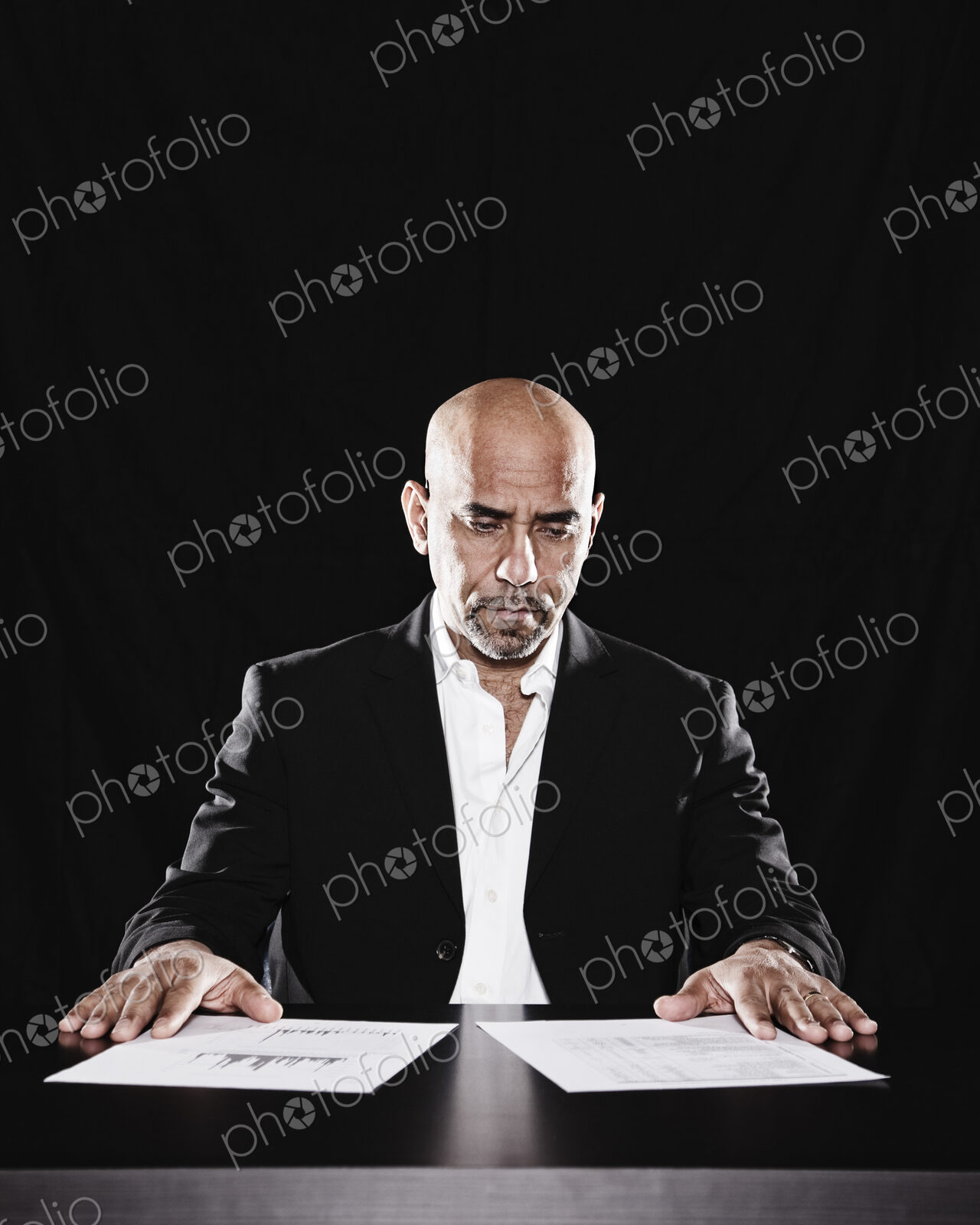 Studio portraits of hispanic man holding props.
