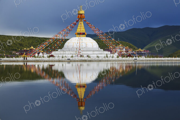 Stupa at the Zhuqing Wujian Zen Forest Monastery, decorated with prayer flags,…