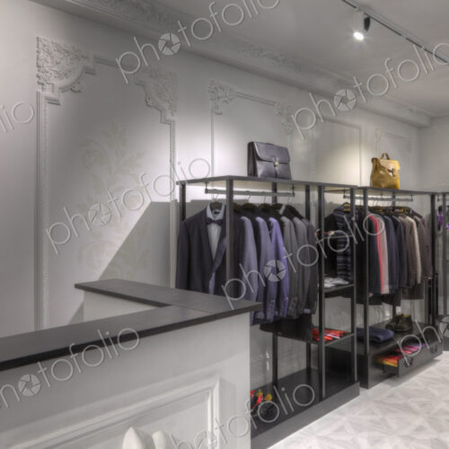 Suits and briefcases in clothing store for men