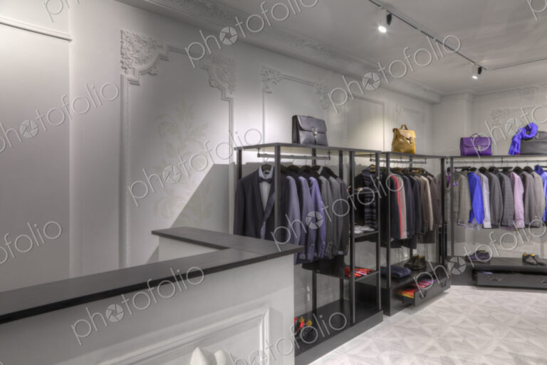 Suits and briefcases in clothing store for men