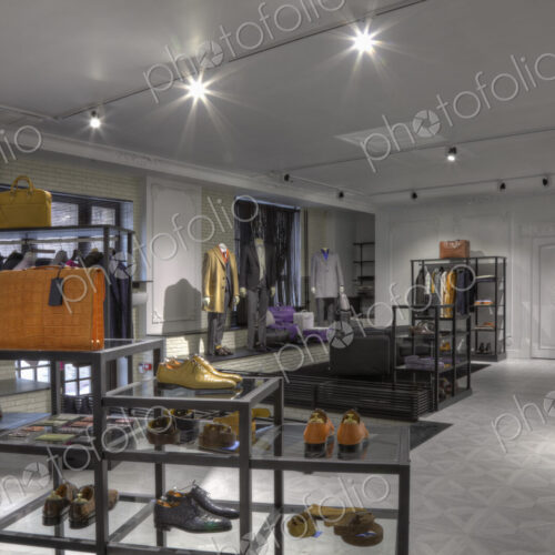 Suits and shoes in clothing store for men Suits and shoes in clothing store for men