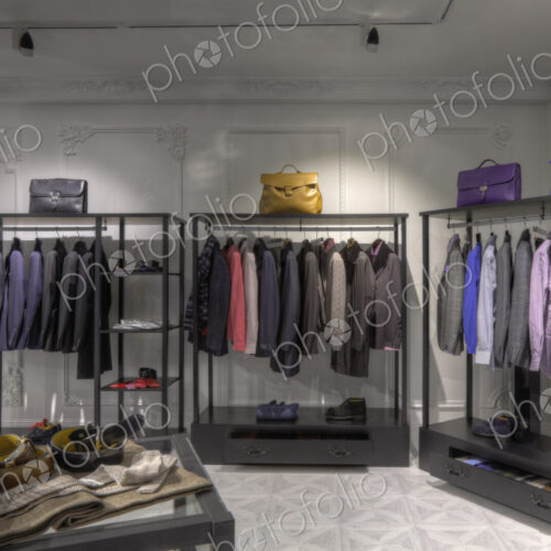 Suits and shoes on racks in clothing store for men Suits and shoes on racks in clothing store for men