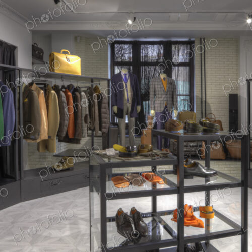 Suits and shoes on racks in clothing store for men Suits and shoes on racks in clothing store for men
