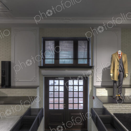 Suits on mannequins near doorway of clothing store for men Suits on mannequins near doorway of clothing store for men