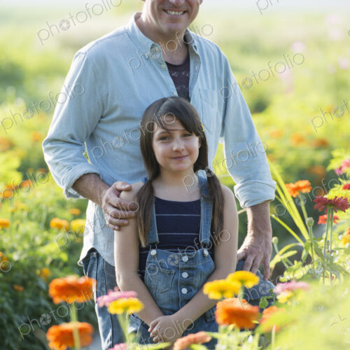 Summer on an organic farm. A man and a girl in a field of flowers. Summer on an organic farm. A man and a girl in a field of flowers.