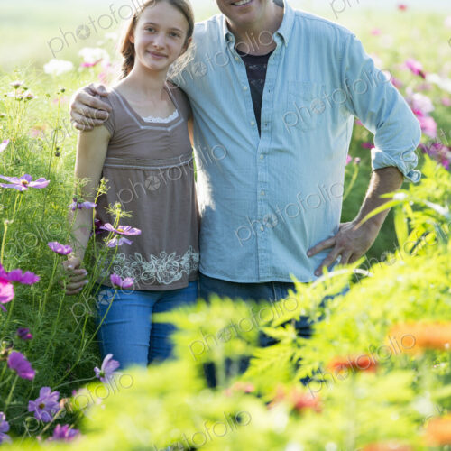 Summer on an organic farm. A man and a girl in a field of flowers. Summer on an organic farm. A man and a girl in a field of flowers.