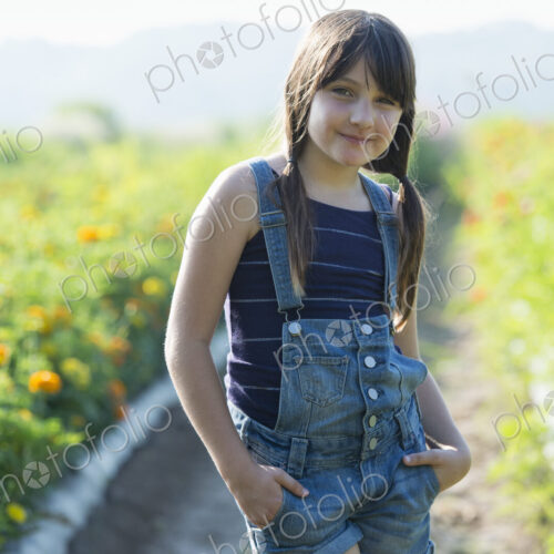 Summer on an organic farm. A young girl in a field of flowers. Summer on an organic farm. A young girl in a field of flowers.