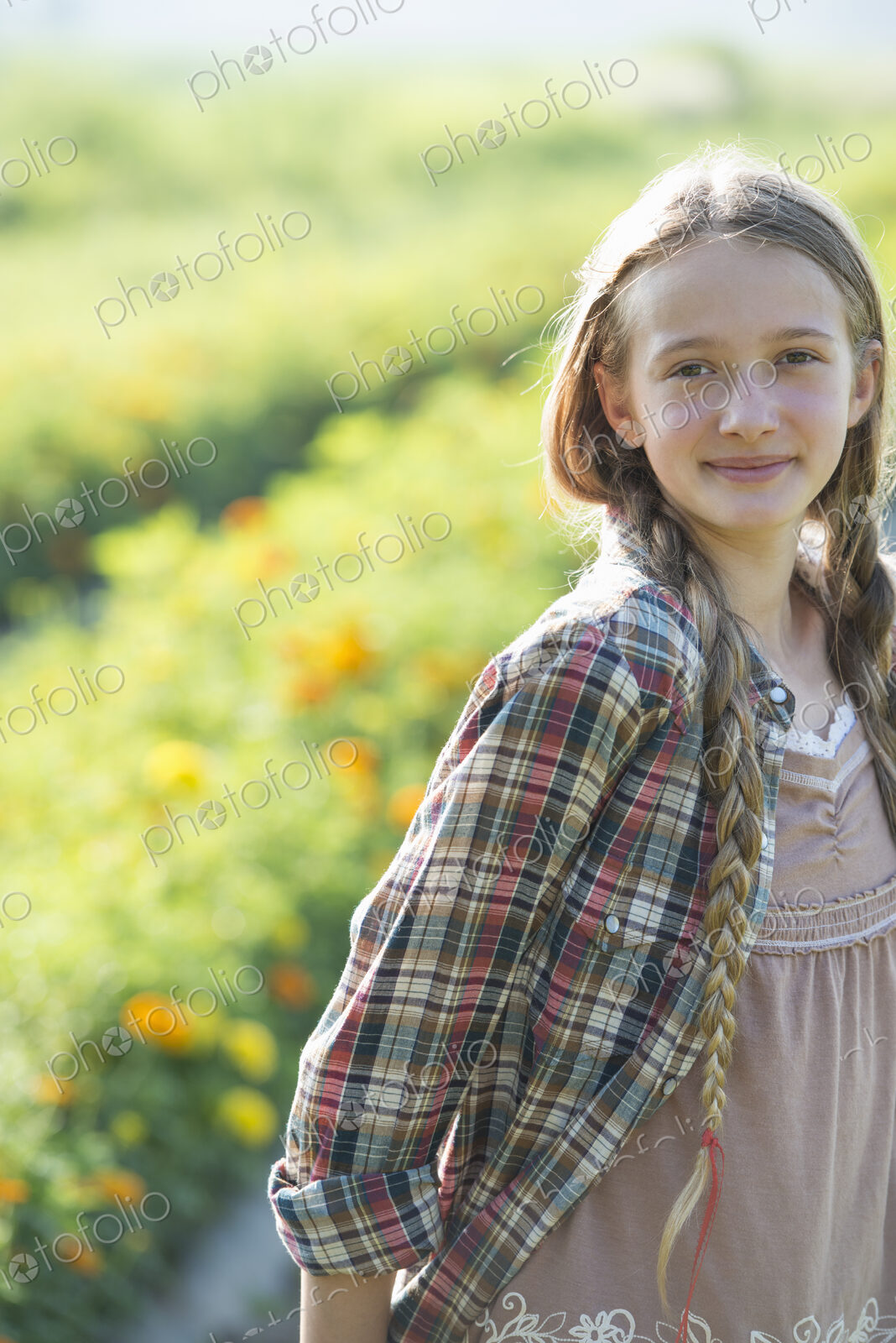 Summer on an organic farm. A young girl in a field of flowers.