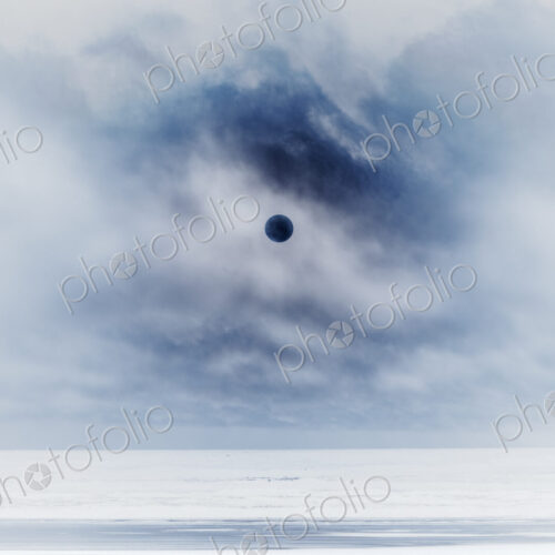 Sun behind clear clouds and fog, vast ocean and beach below, Long Beach Peninsula