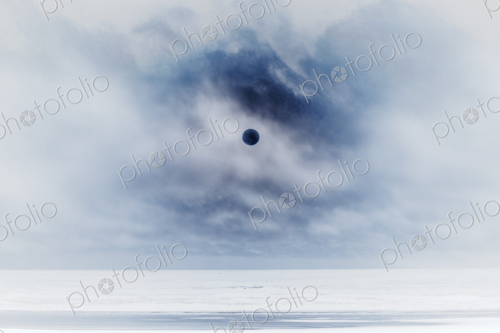 Sun behind clear clouds and fog, vast ocean and beach below, Long Beach Peninsula