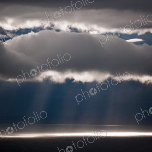 Sun rays stream down thru clouds, Kamai National Park, Alaska, USA Sun rays stream down thru clouds, Kamai National Park, Alaska, USA