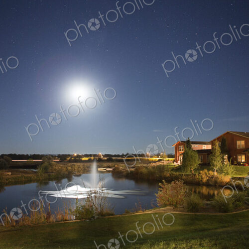 Sun rising over fountain in rural landscape Sun rising over fountain in rural landscape