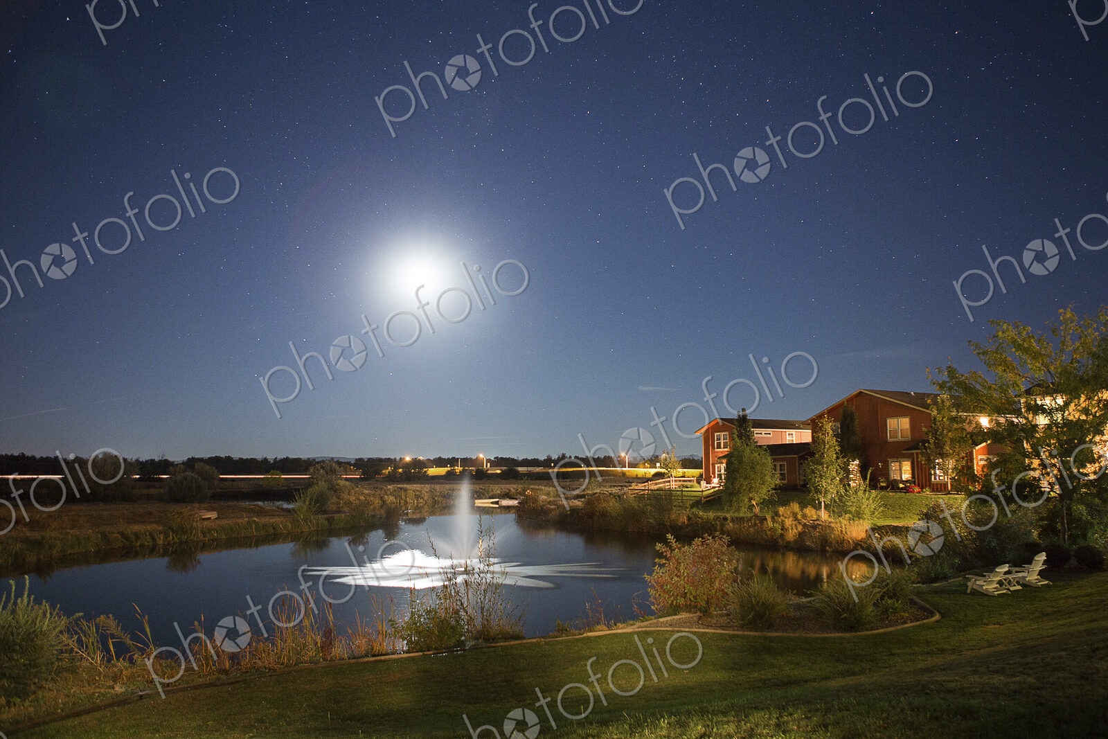 Sun rising over fountain in rural landscape