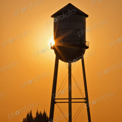 Sun setting behind agricultural water tower. Sun setting behind agricultural water tower.