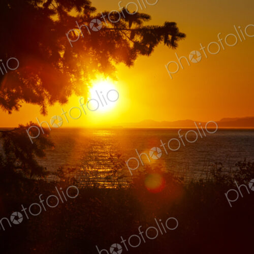 Sun setting on the Strait of Juan de Fuca over Vancouver Island, Canada