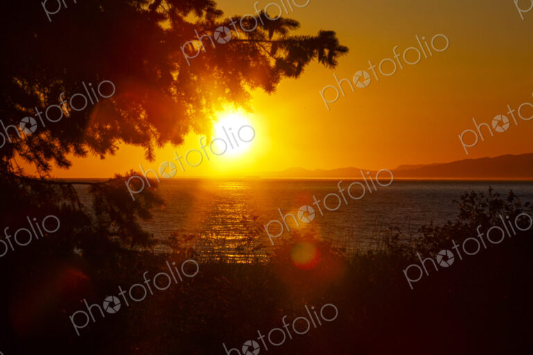 Sun setting on the Strait of Juan de Fuca over Vancouver Island, Canada