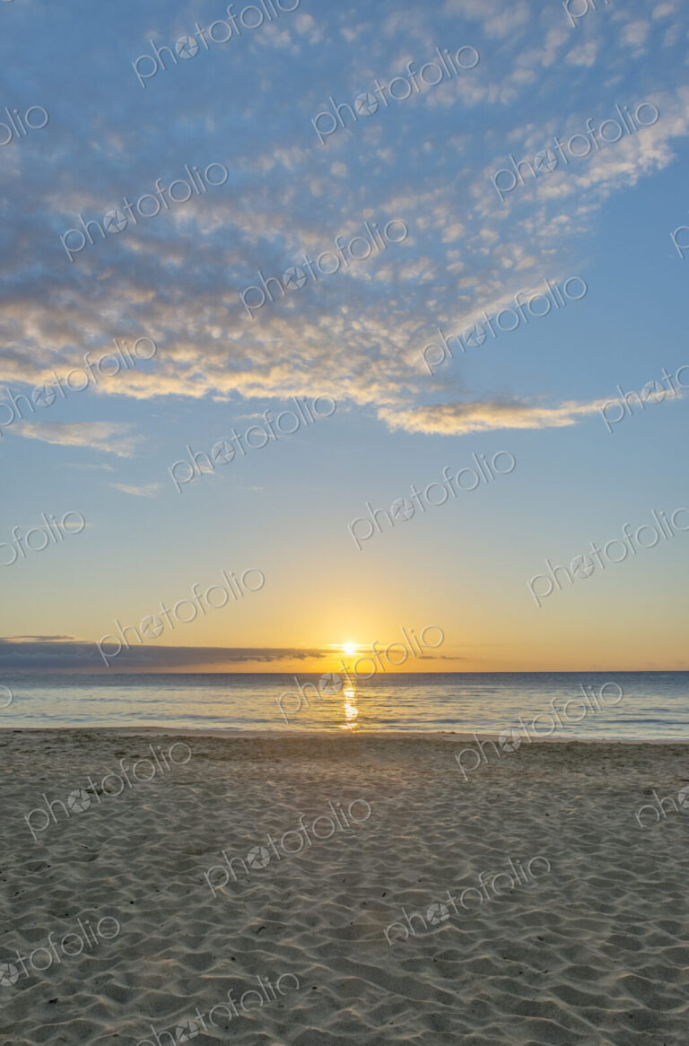 Sun setting over Wailua beach, Kauai.