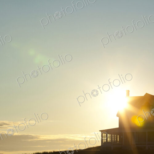 Sun shining behind rural house Sun shining behind rural house