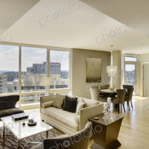 Sun shining through windows of open floor plan in luxury highrise apartment Sun shining through windows of open floor plan in luxury highrise apartment