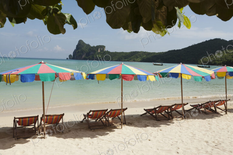 Sun umbrellas on a beach in the Andaman islands off the coast of Thailand.