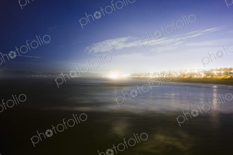 Sunlight on lake in urban area.
