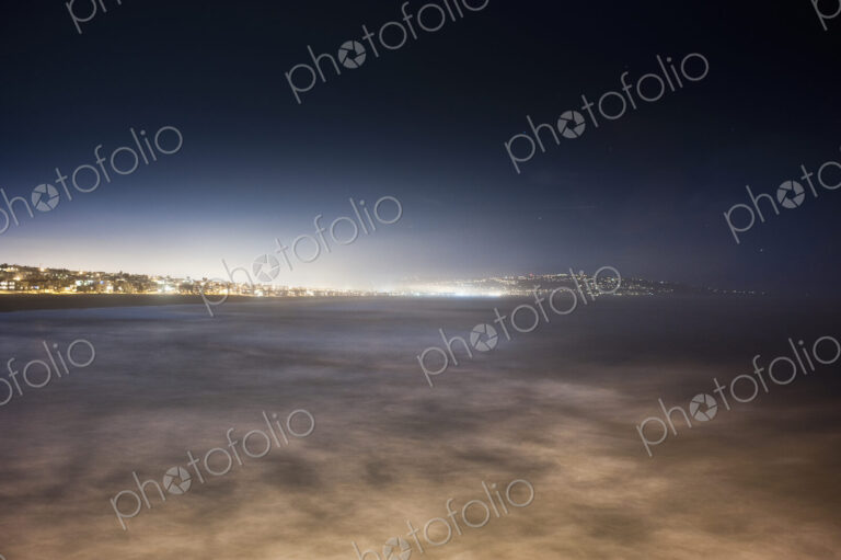 Sunlight on lake or sea in urban area.