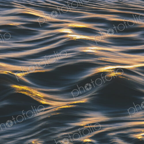 Sunlight reflecting on small waves on the ocean surface.