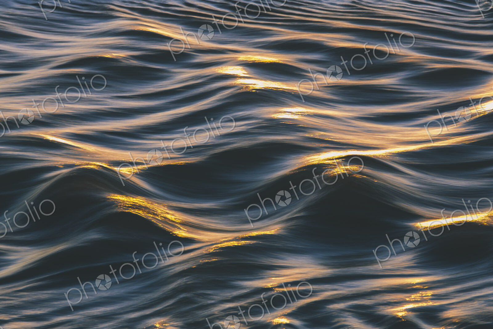 Sunlight reflecting on small waves on the ocean surface.