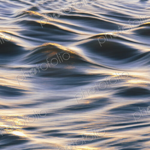 Sunlight reflecting on small waves on the ocean surface.
