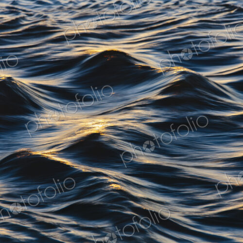 Sunlight reflecting on small waves on the ocean surface.