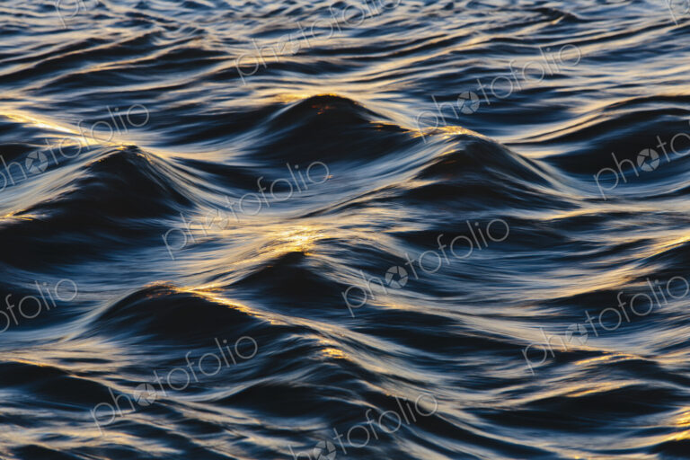Sunlight reflecting on small waves on the ocean surface.