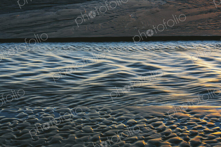 Sunlight reflecting on small waves on the ocean surface.