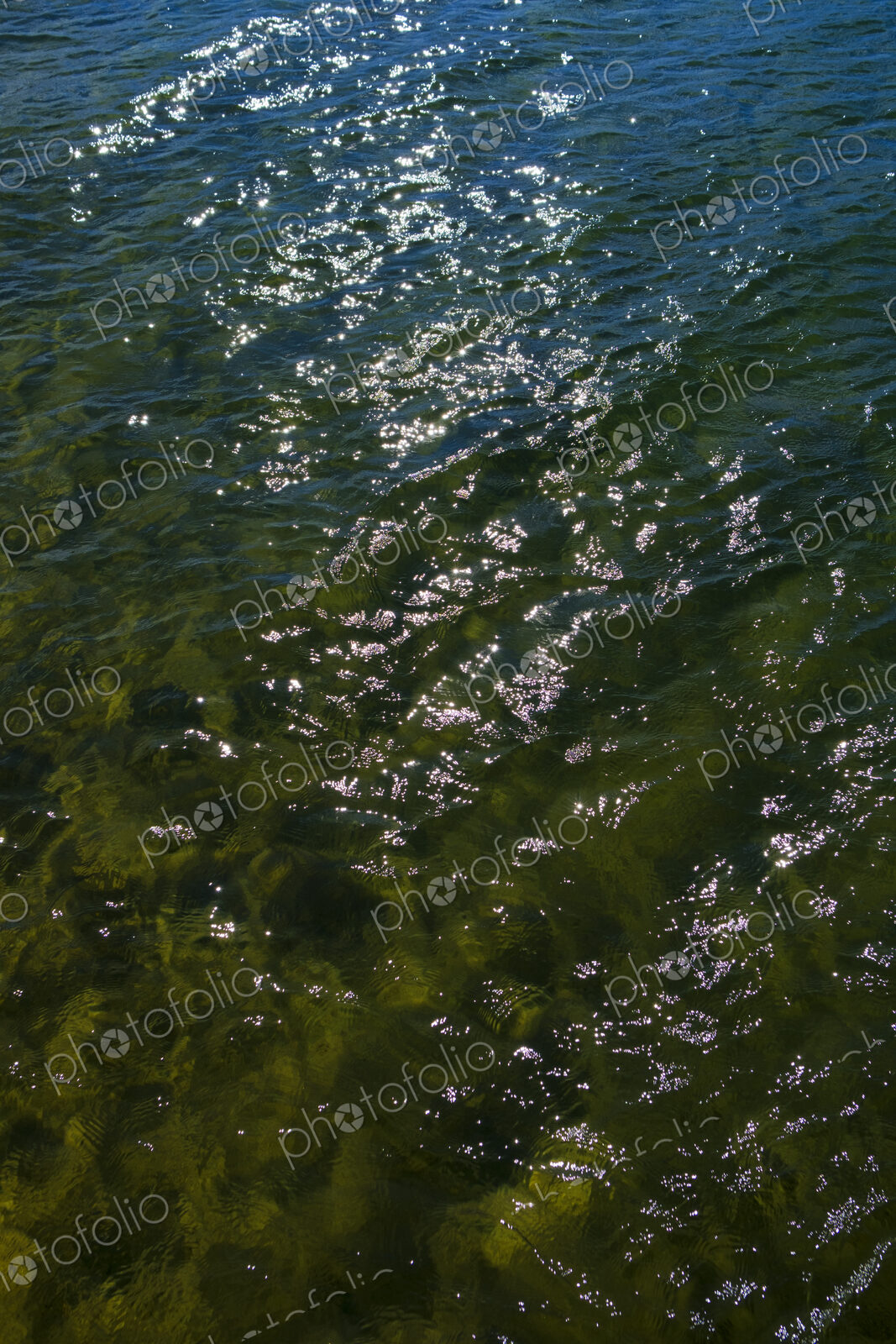 Sunlight relfecting on clear waters of Lake Tahoe, High Sierra, CA, USA