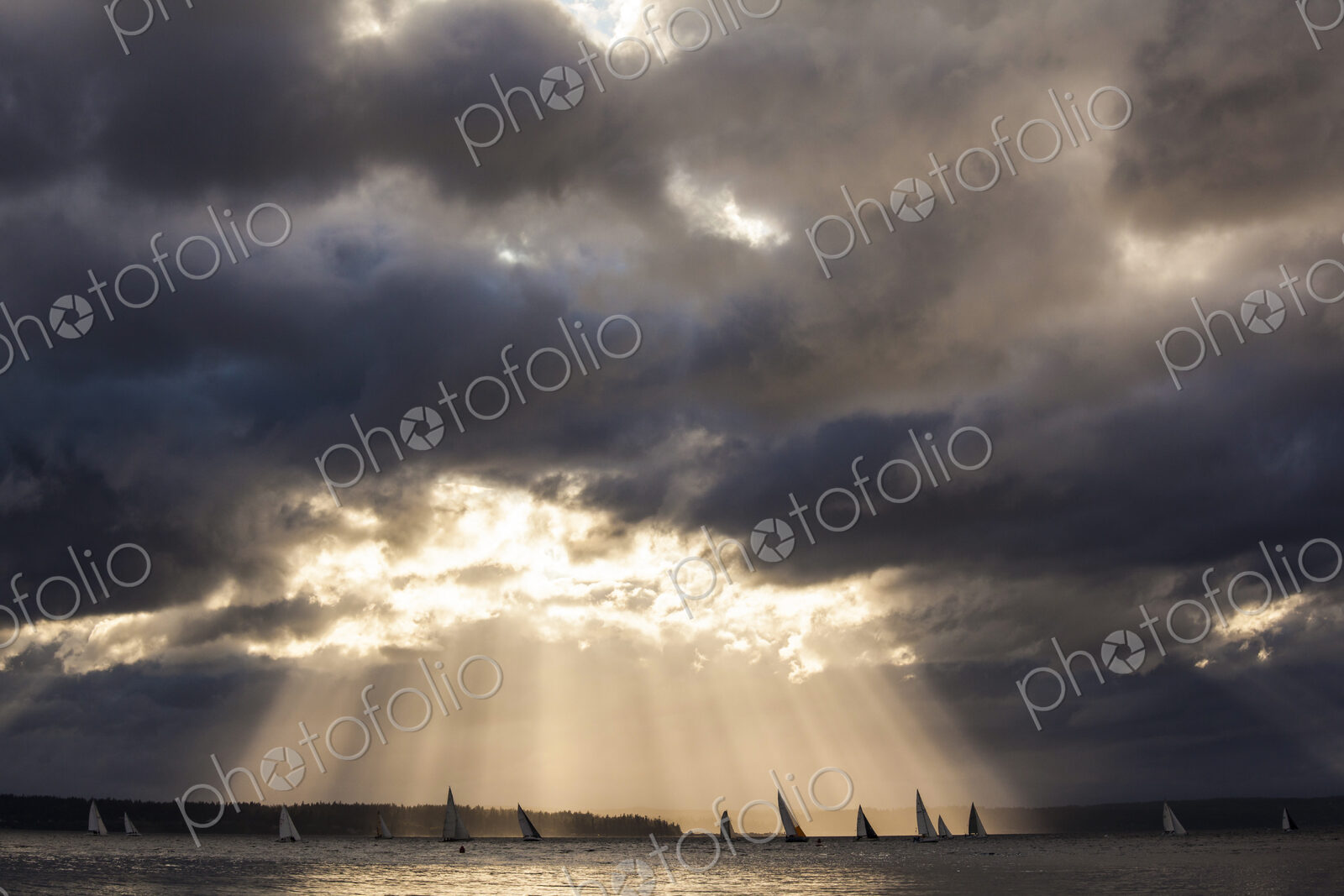 Sunlight streaming though storm clouds, Puget Sound.