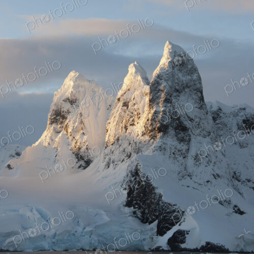 Sunrise on the mountain tops at the north entrance to the Lemaire Channel Sunrise on the mountain tops at the north entrance to the Lemaire Channel