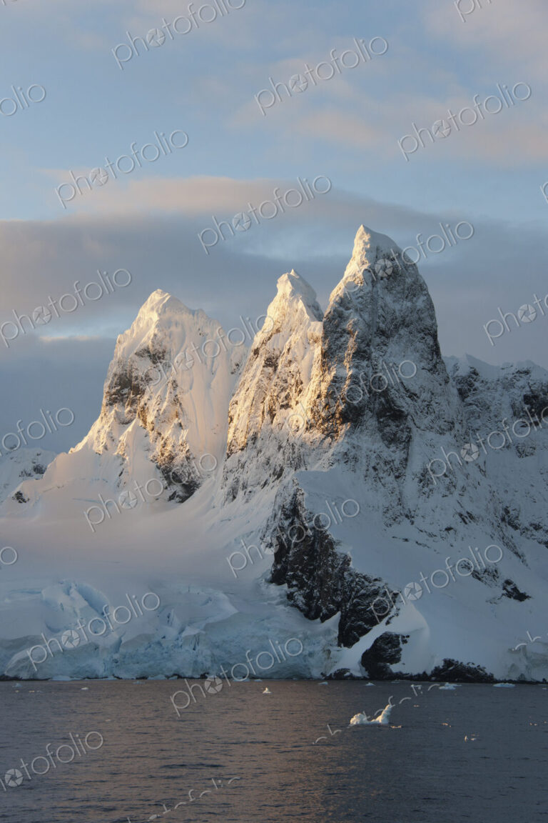 Sunrise on the mountain tops at the north entrance to the Lemaire Channel