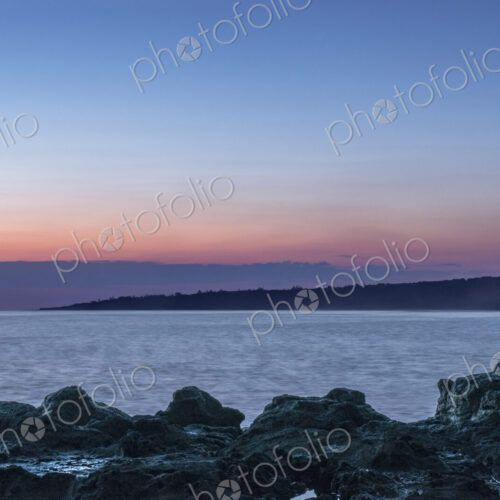 Sunrise over rock formations on beach Sunrise over rock formations on beach