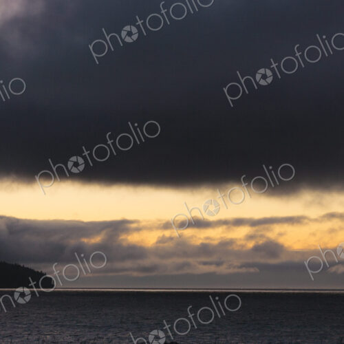 Sunset and dark clouds over the Strait of Juan de Fuca. Sunset and dark clouds over the Strait of Juan de Fuca.
