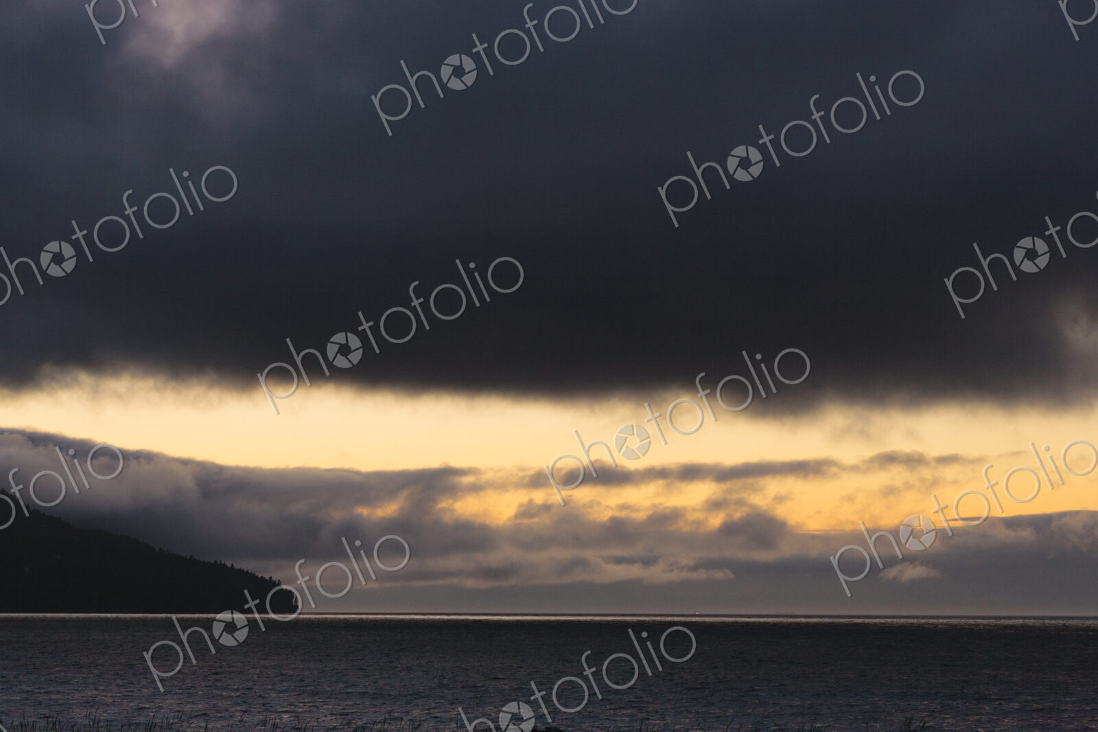 Sunset and dark clouds over the Strait of Juan de Fuca.